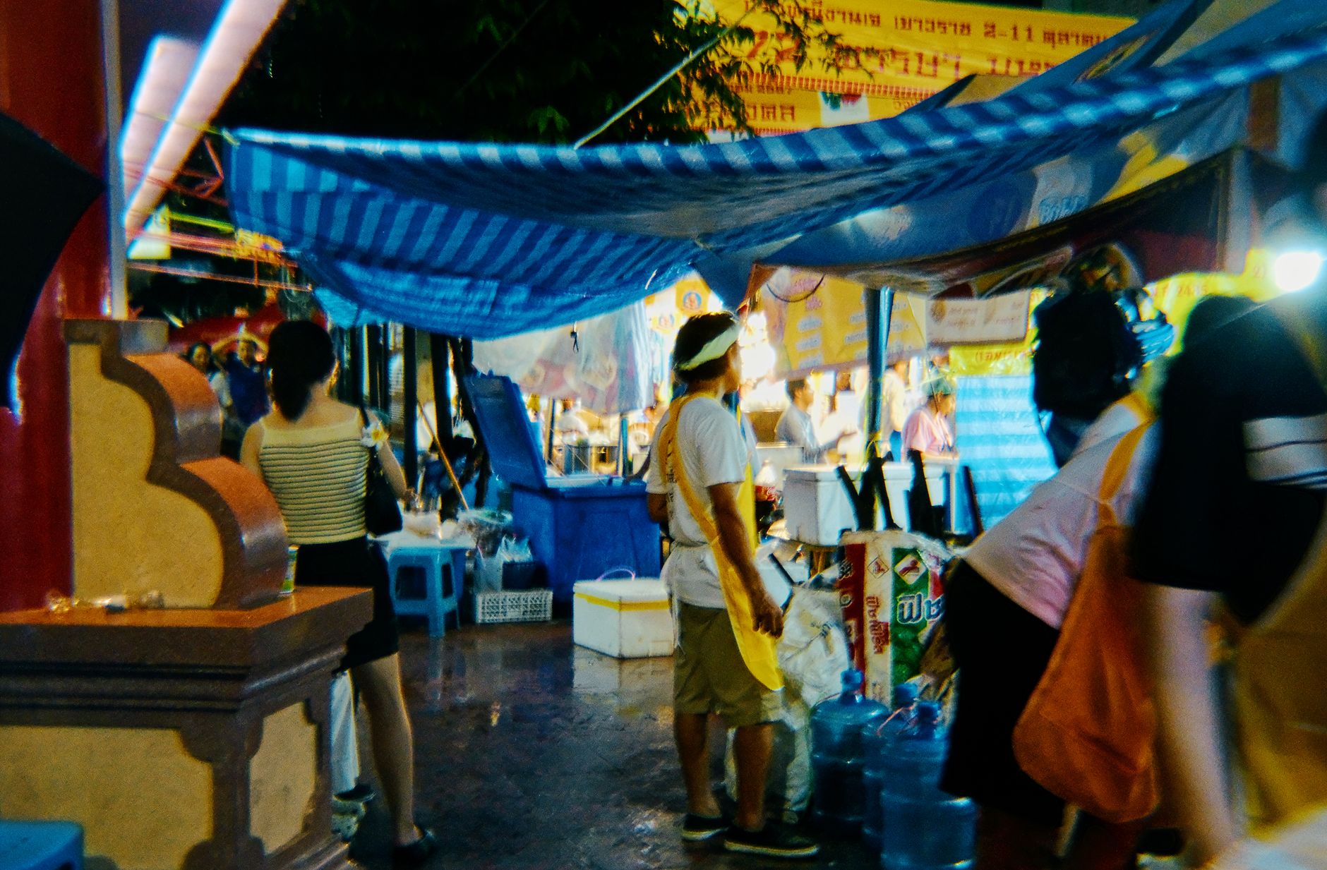 bangkok street market rainy evening umbrellas